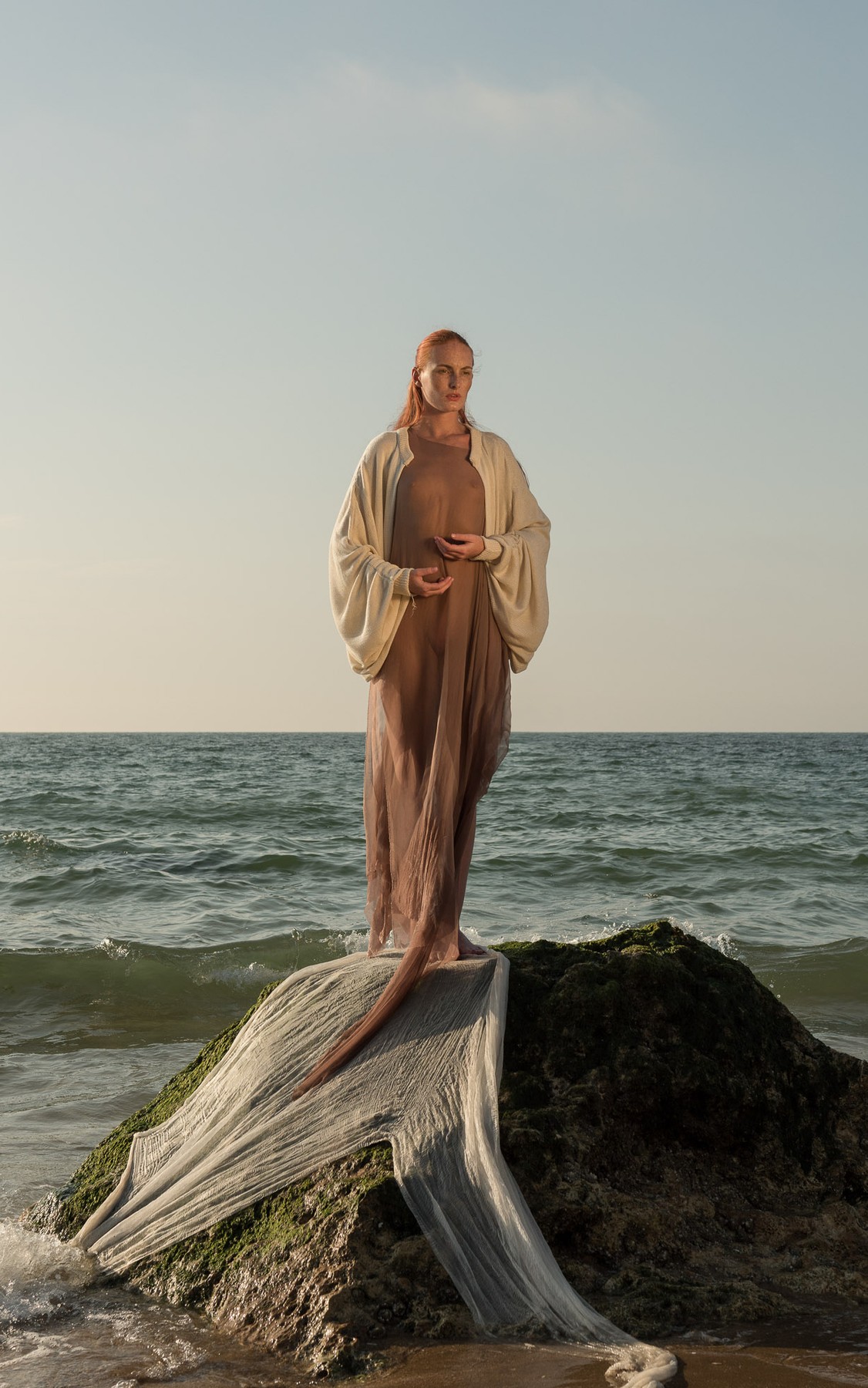 Anki Top, worn on a rock by the sea