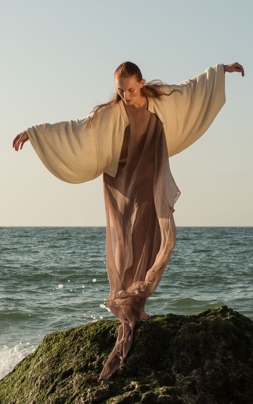 Anki Top, arms open by the sea